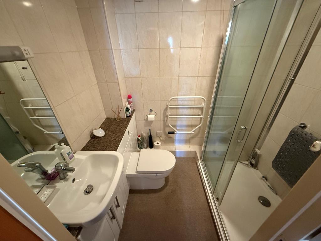 Lot: 128 - TWO-BEDROOM GROUND FLOOR RETIREMENT FLAT - Bathroom with walk in shower sink and toilet
